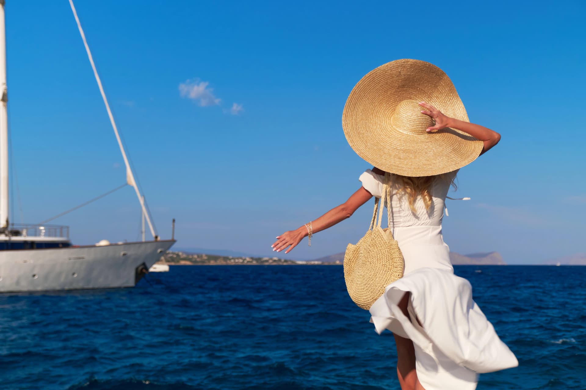 Beautiful girl tourist walking at Spetses marina seaport, Greece