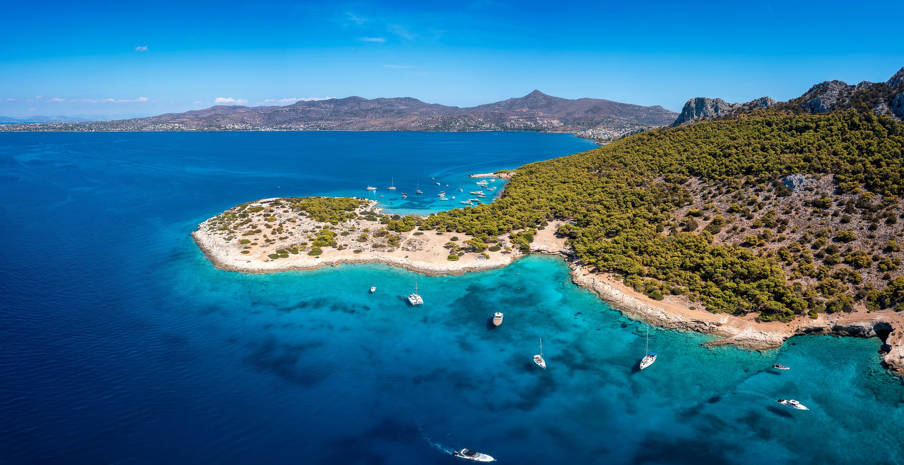 The beautiful coast of Moni island, next to Aigina in the Saronic Gulf of Athens with turqoise sea and lush, green hills