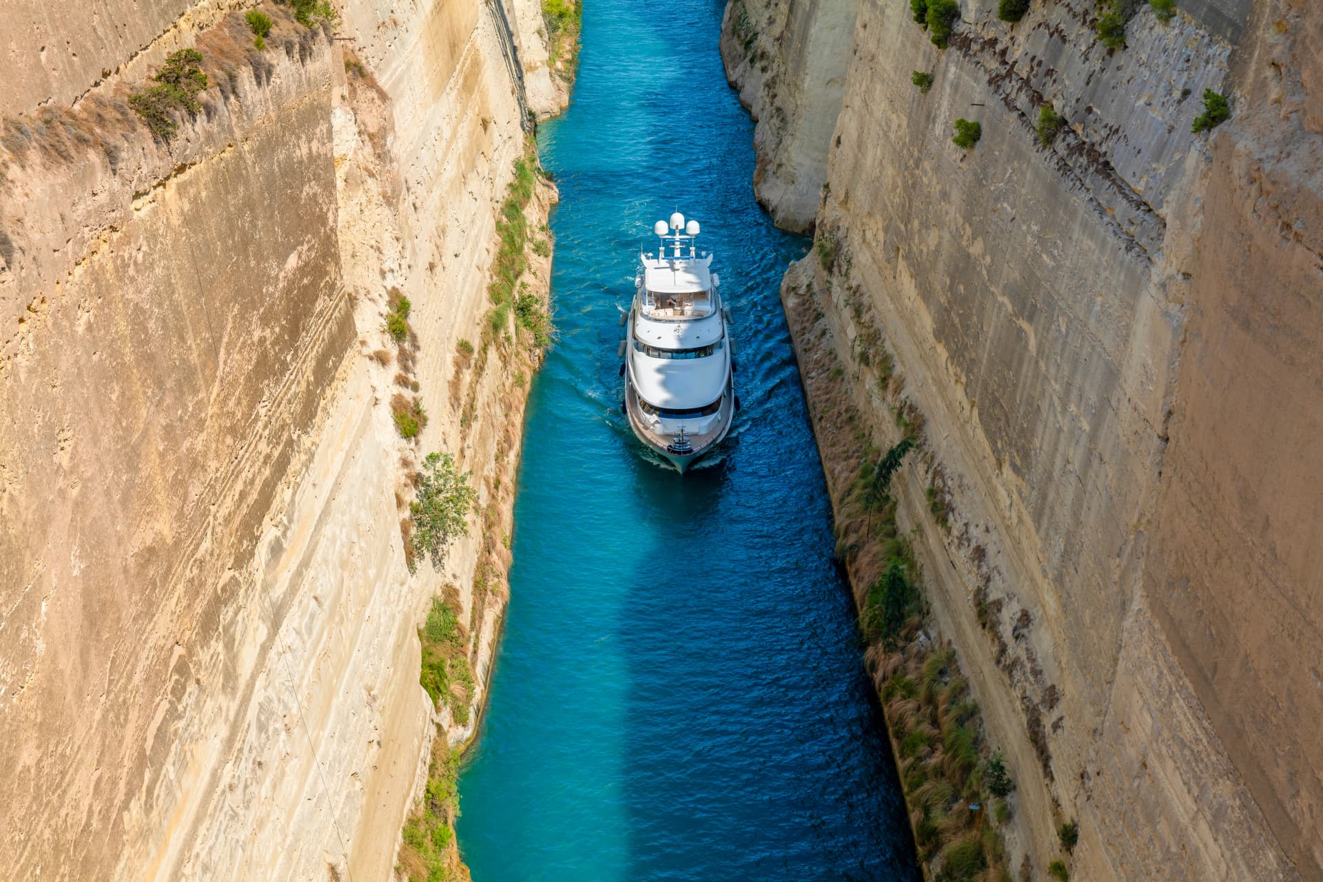 Greece Peloponnese Corinth Canal and a boat passing through the canal