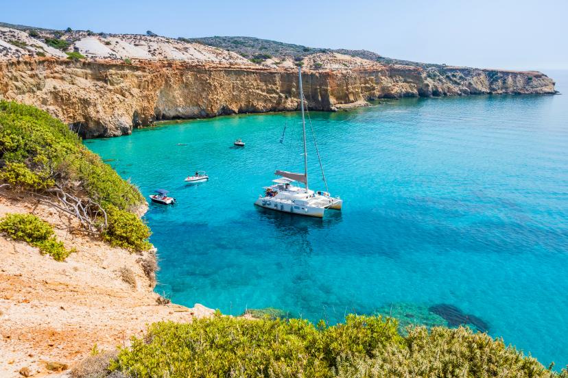 View of catamaran boat on sea coast near Tsigrado beach, Milos island, Cyclades, Greece